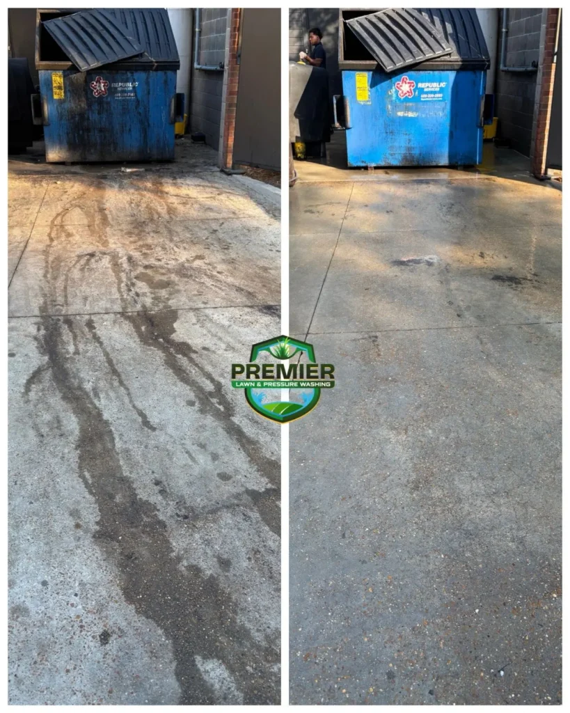 Before and after comparison of a concrete surface in front of a dumpster, showing it cleaned of stains by Premier Lawn & Pressure Washing.