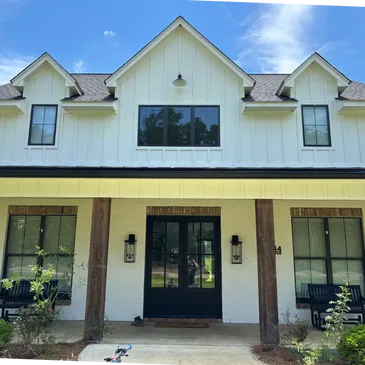 Clean house exterior after performing a house wash.