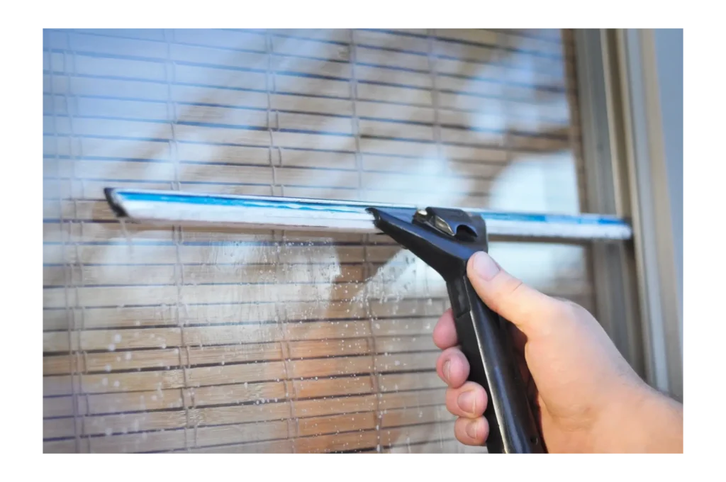 Window being cleaned with a squeegee in Pearl, MS.