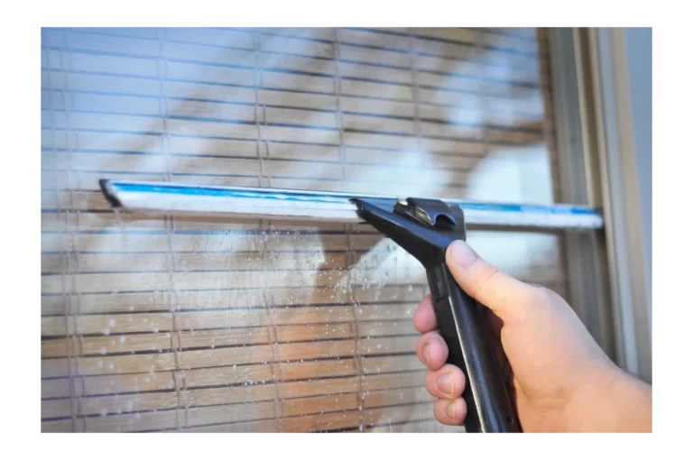 Window being cleaned with a squeegee in Pearl, MS.
