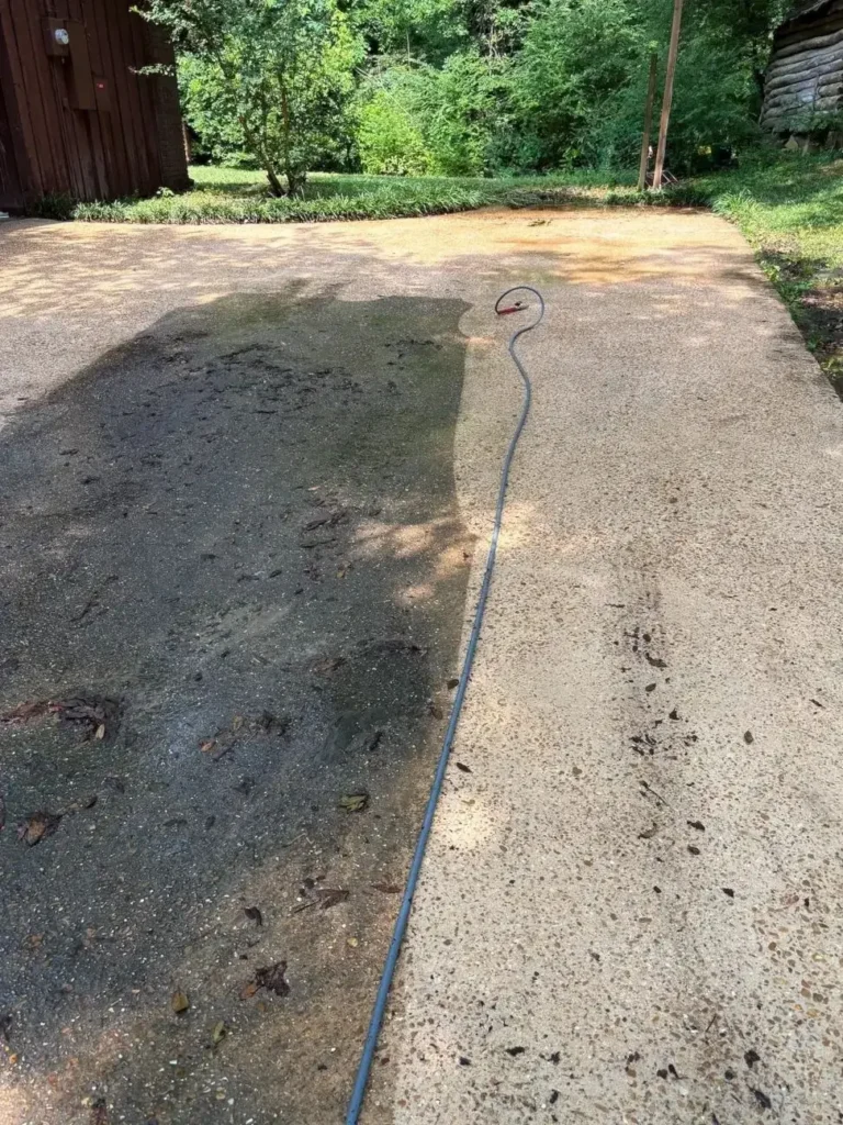 Before and after picture of a driveway cleaning in Jackson, MS.